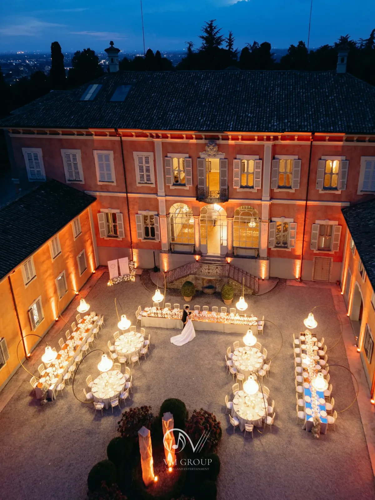 Matrimonio serale nel cortile di Villa Subaglio a Merate: tavoli illuminati e sposi al centro